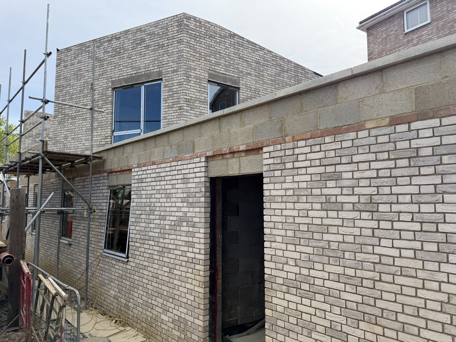 Light brick residential building with precise corners and window openings
