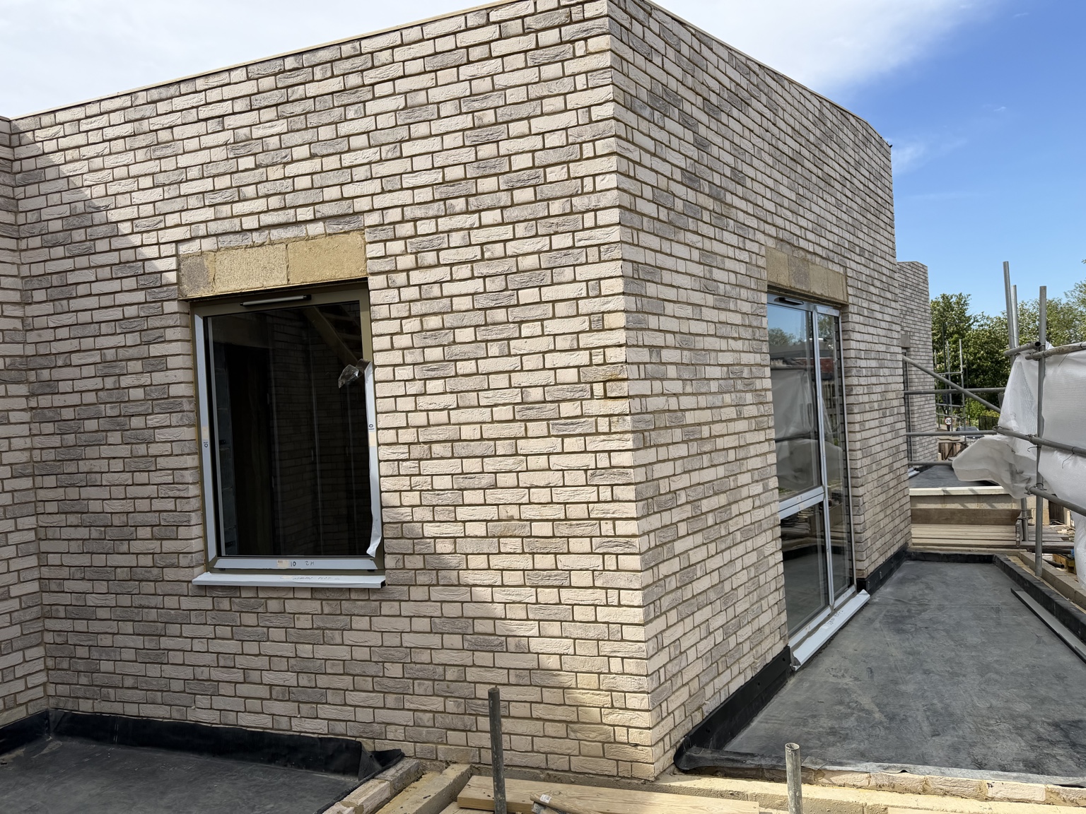 Detailed light brick elevation with fitted windows