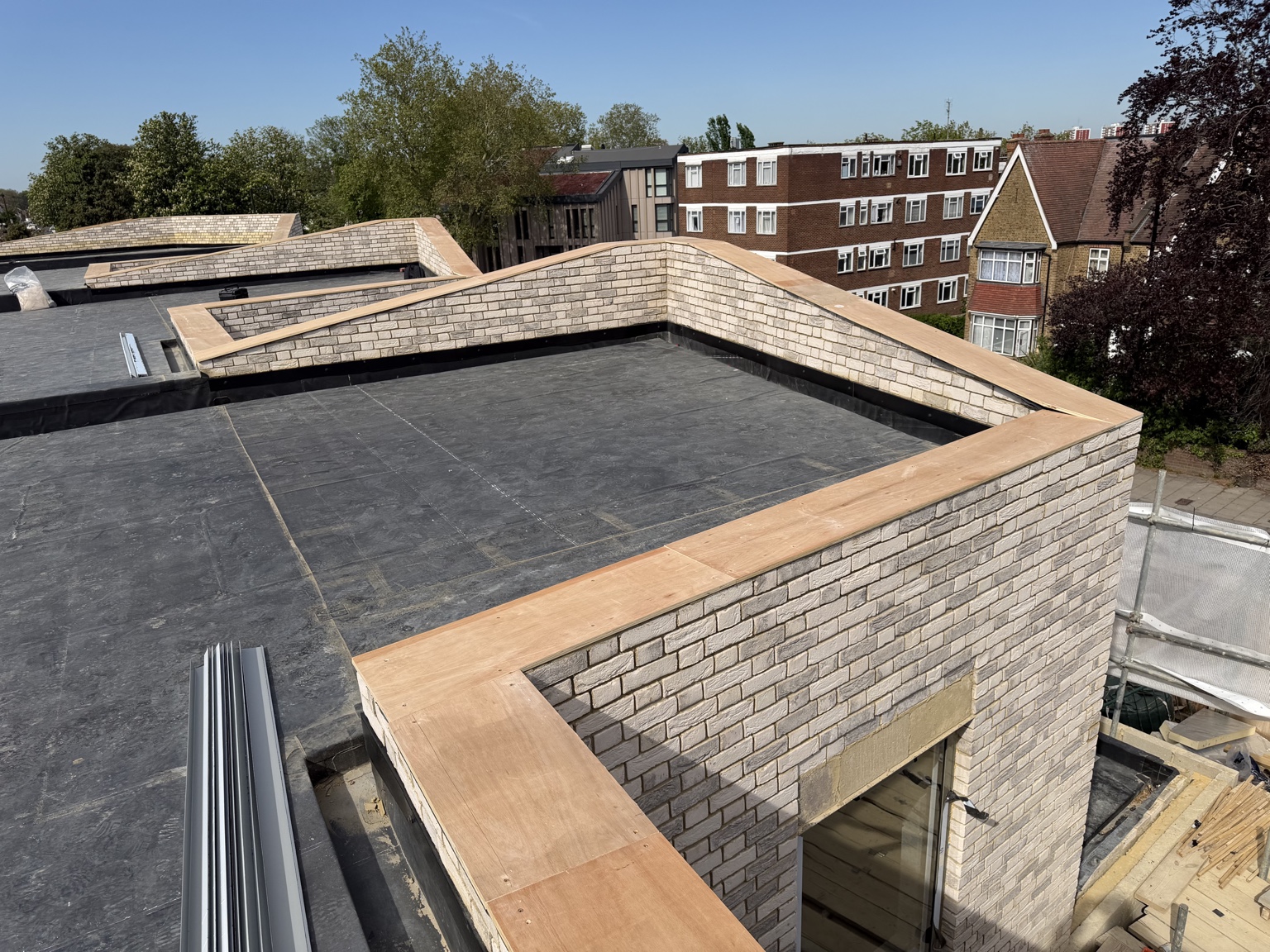 Brick parapet walls around a flat roof