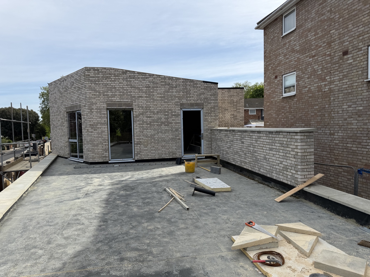 Completed light brick extension and terrace walls